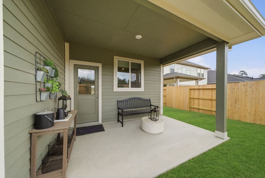 A house with a bench and a table.