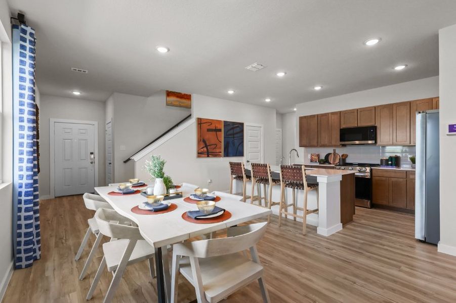 A kitchen with a dining table.