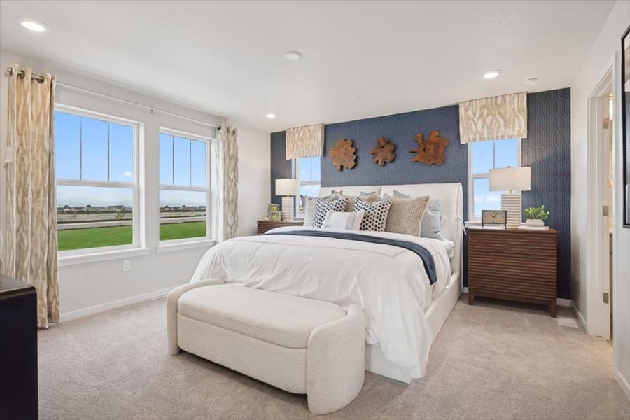 A bedroom with a large bed and a large window.