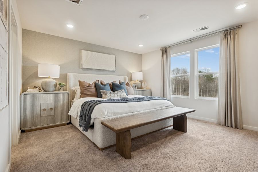A bedroom with a bed and a bench. A bedroom with a bed and a bench.