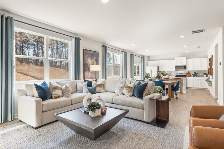 A living room with a large window. A living room with a large window.
