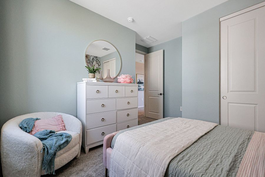 A bedroom with a mirror and a bed. A bedroom with a mirror and a bed.