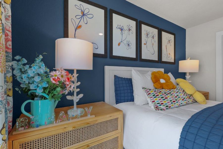 A bedroom with a bed and a lamp.
