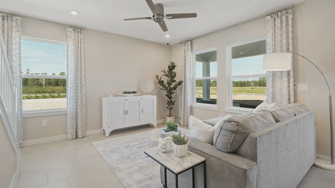 Cyrene at Harmony by DRB Homes features a spacious living room with three large windows—filling the space with natural light. Cyrene at Harmony by DRB Homes features a spacious living room with three large windows—filling the space with natural light.