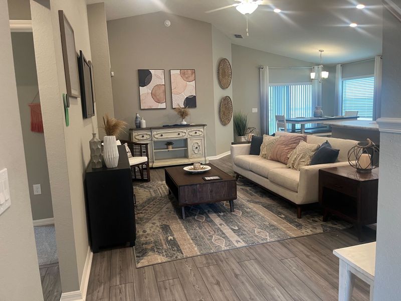 A cozy living area with a neutral palette, stylish wall art, and elegant lighting, ideal for relaxation and modern living.