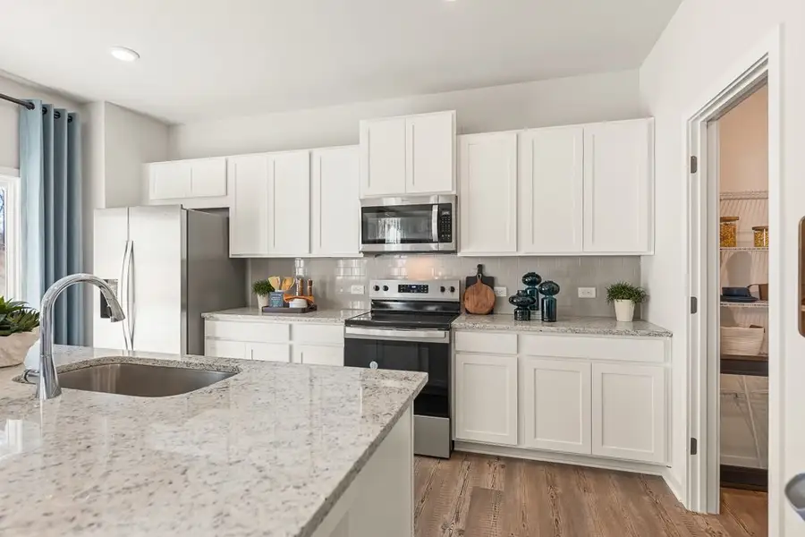 A kitchen with white cabinets. A kitchen with white cabinets.