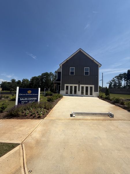 A modern sales center with lush landscaping in Campground Crossing by Dream Finders Homes (Mcdonough, GA). A modern sales center with lush landscaping in Campground Crossing by Dream Finders Homes (Mcdonough, GA).