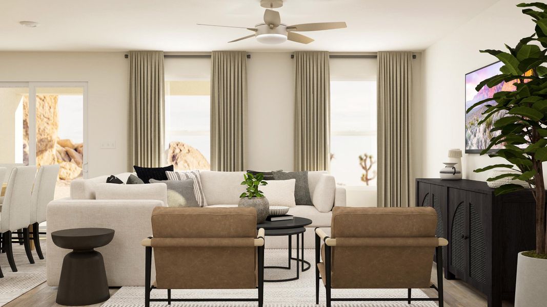 A living room with a white couch and a fan.