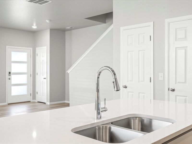 Kitchen in the Woodland floorplan at a Meritage Homes community in Broomfield, CO.