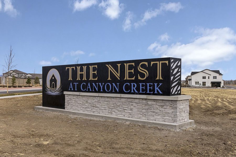 Entrance to the The Nest Reserve at Canyon Creek community in Erie, CO, featuring signage and landscaping (Image 1). Entrance to the The Nest Reserve at Canyon Creek community in Erie, CO, featuring signage and landscaping (Image 1).