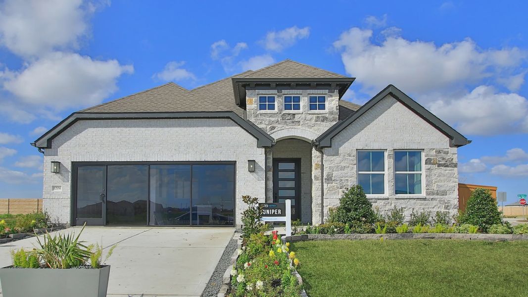 Elegant facade featuring premium brick and stone detailing in River Ranch. Beautifully landscaped entry.