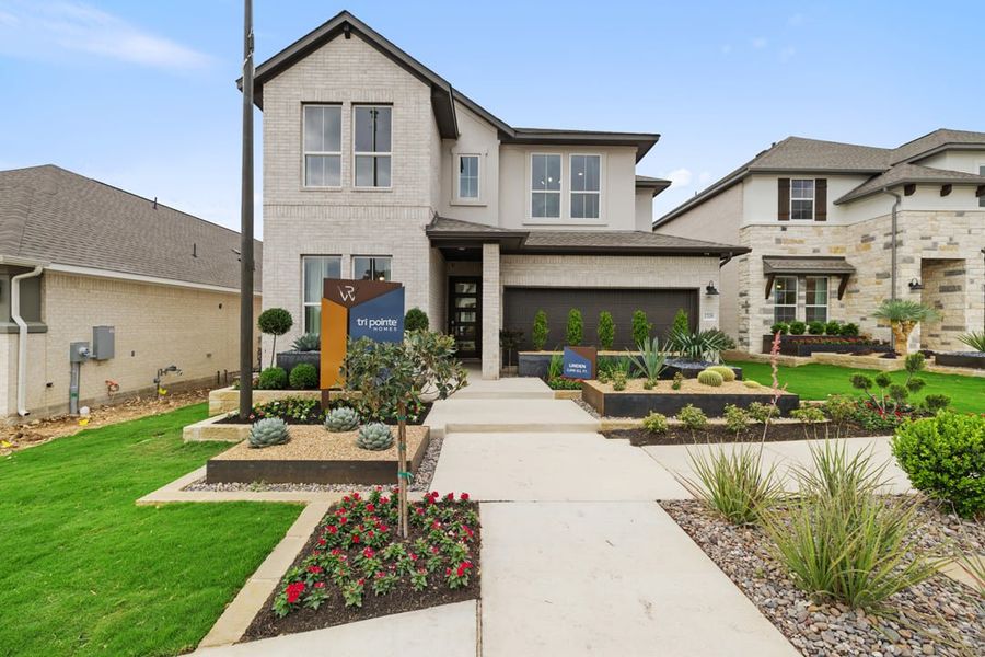 Front exterior of a home in the Arbor Collection At Wolf Ranch community, located in Georgetown, TX (Image 2).