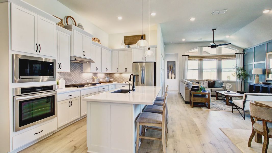 Exquisite open-plan kitchen with sleek island, airy living space, and elegant finishes in Veranda community.