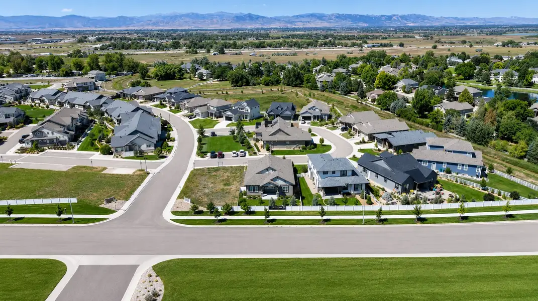 Aerial view of the Country Farms Village - The Cottages community in Windsor, CO, showing layout and nearby surroundings (Image 1). Aerial view of the Country Farms Village - The Cottages community in Windsor, CO, showing layout and nearby surroundings (Image 1).