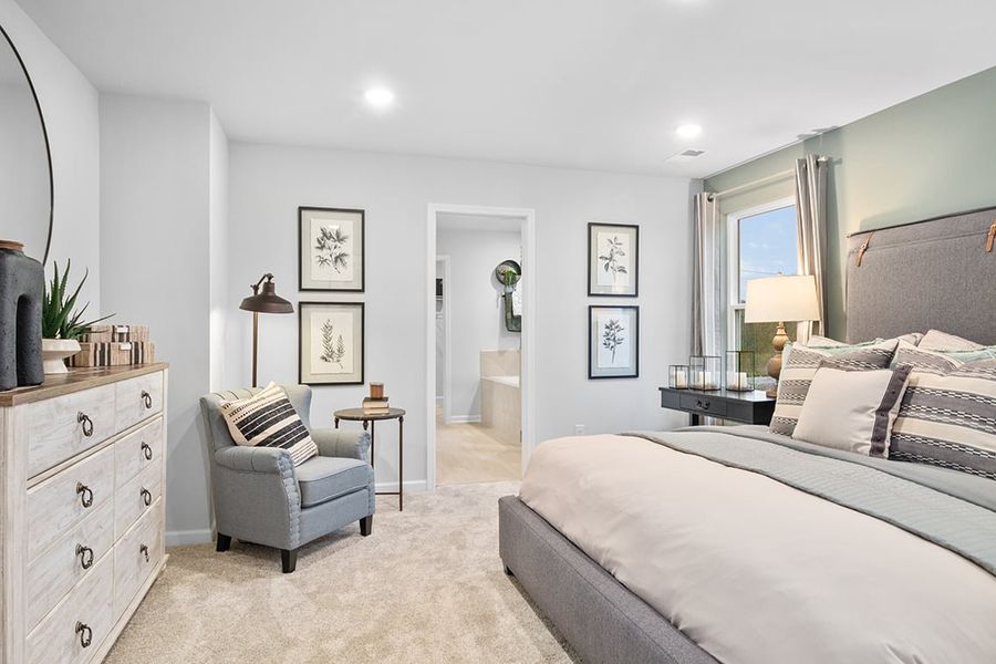 A bedroom with a bed and a chair. A bedroom with a bed and a chair.