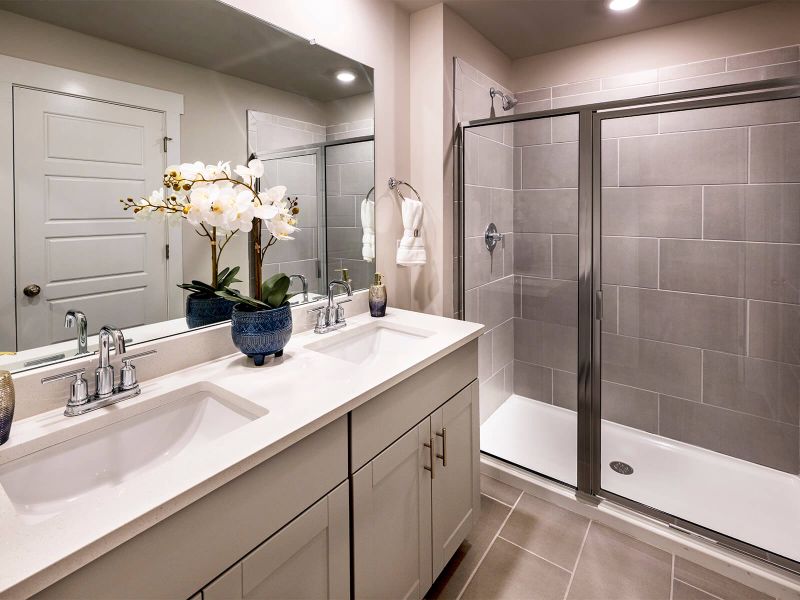 The primary bath offers a large walk-in shower. Photography from Townes at Garrison Grove. The primary bath offers a large walk-in shower. Photography from Townes at Garrison Grove.
