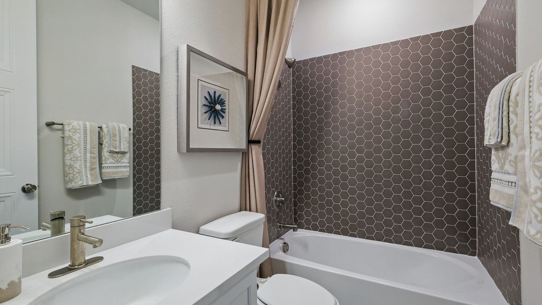 Features refined hexagonal tiling and premium fixtures, showcasing Green Oaks Preserve's luxury. Features refined hexagonal tiling and premium fixtures, showcasing Green Oaks Preserve's luxury.