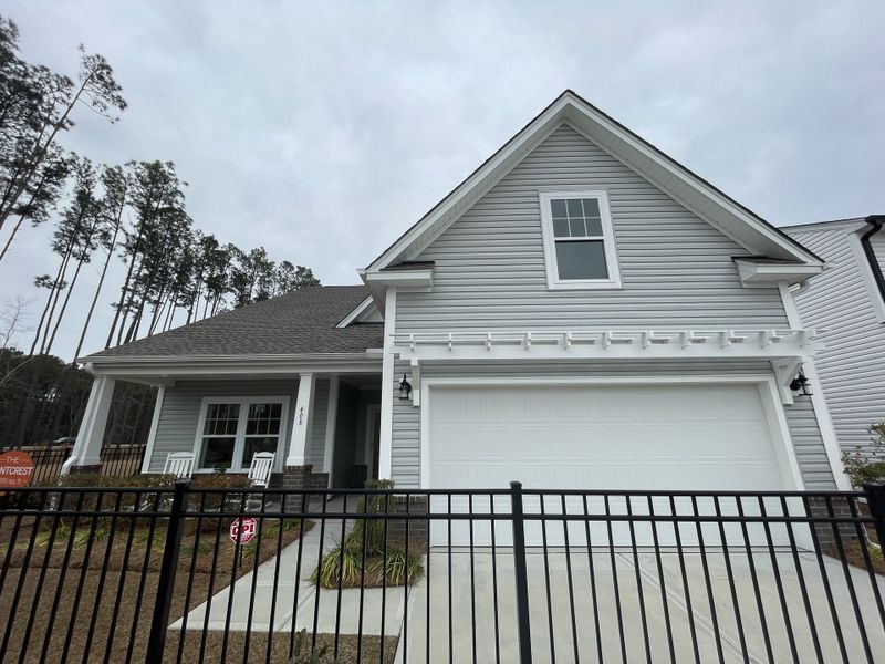 A charming gray home with a front porch in North Creek at Nexton by True Homes (Summerville, SC).