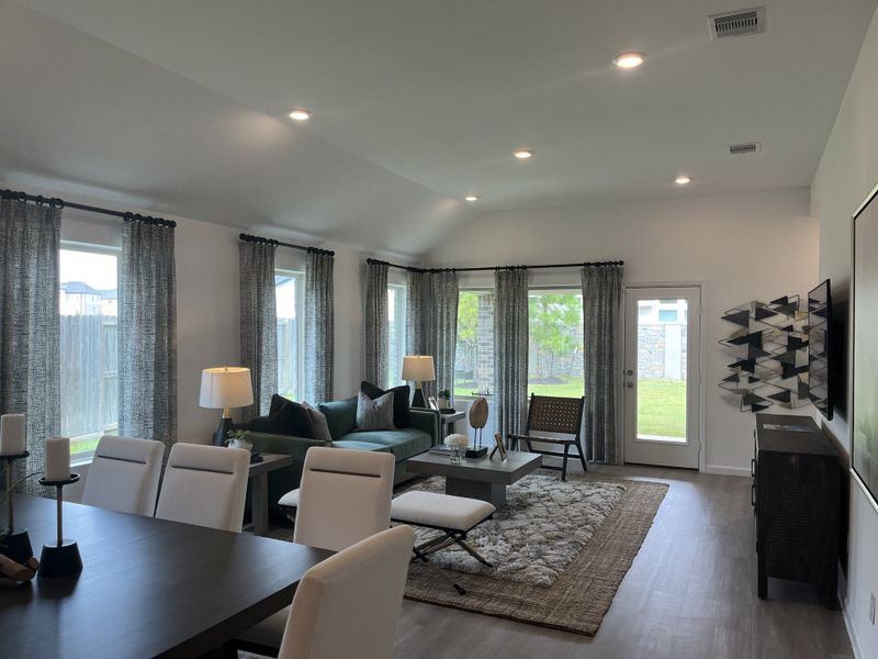A spacious living area with large windows, modern furniture, and stylish decor, offering comfort and elegance.