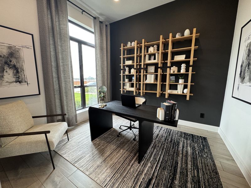 A modern home office with a dark accent wall, stylish shelving, sleek desk, and large window with elegant drapes. A modern home office with a dark accent wall, stylish shelving, sleek desk, and large window with elegant drapes.
