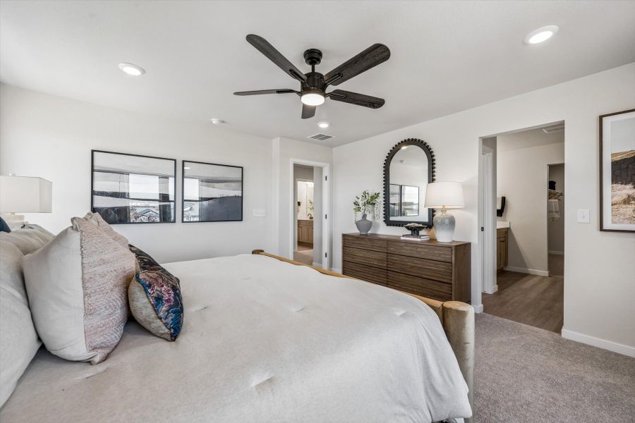 A bedroom with a bed and a fan. A bedroom with a bed and a fan.