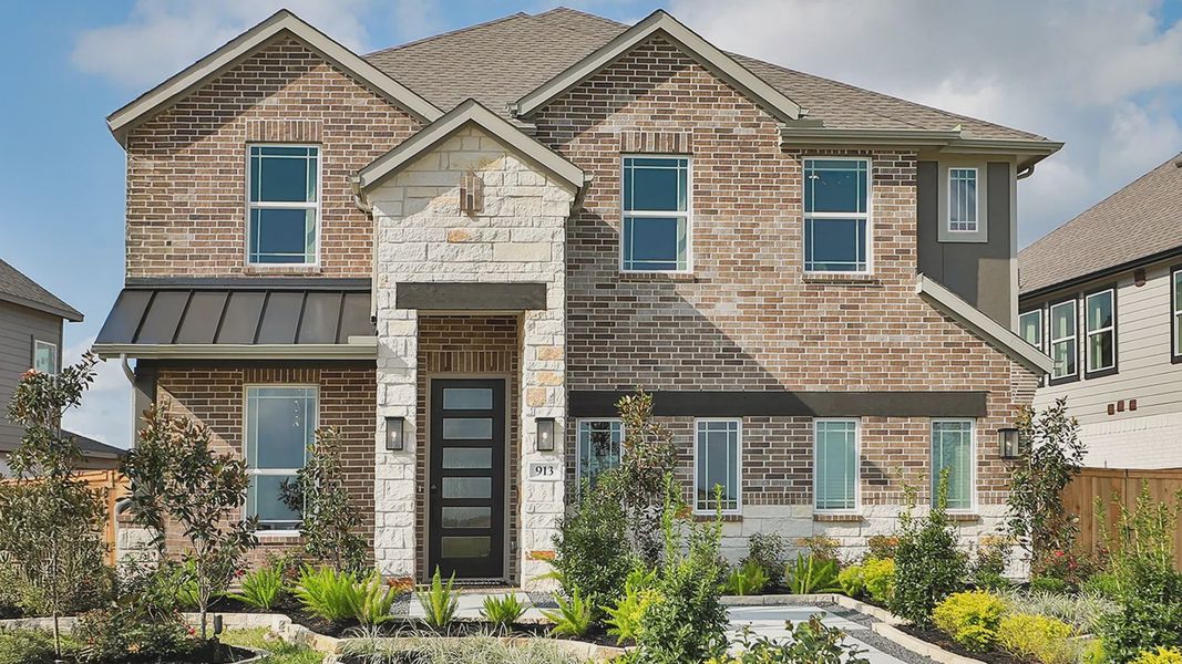 Elegant facade featuring premium brick and stone detailing in River Ranch. Beautifully landscaped entry. Elegant facade featuring premium brick and stone detailing in River Ranch. Beautifully landscaped entry.