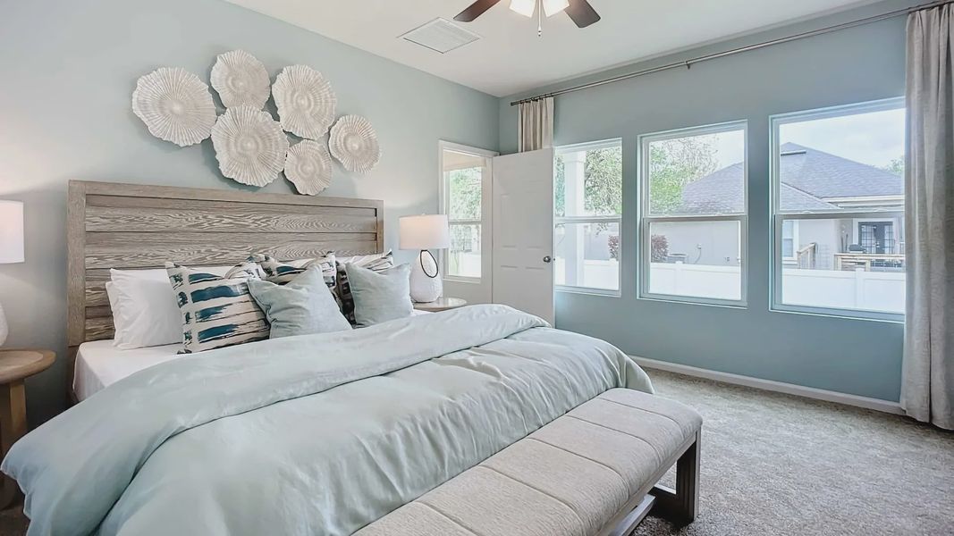 Discover serenity in this Panther Creek bedroom with expansive windows and artistic textures.