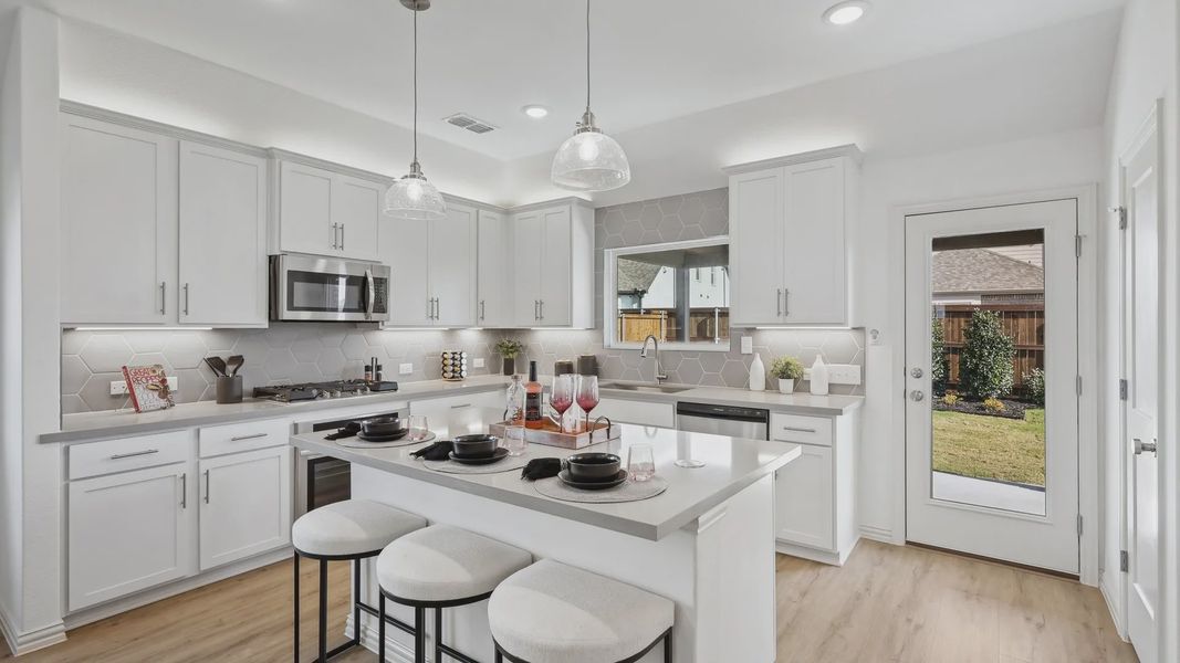 Elegant Bel Air Village kitchen showcases sleek white cabinetry and chic hexagonal backsplash for a modern feel.