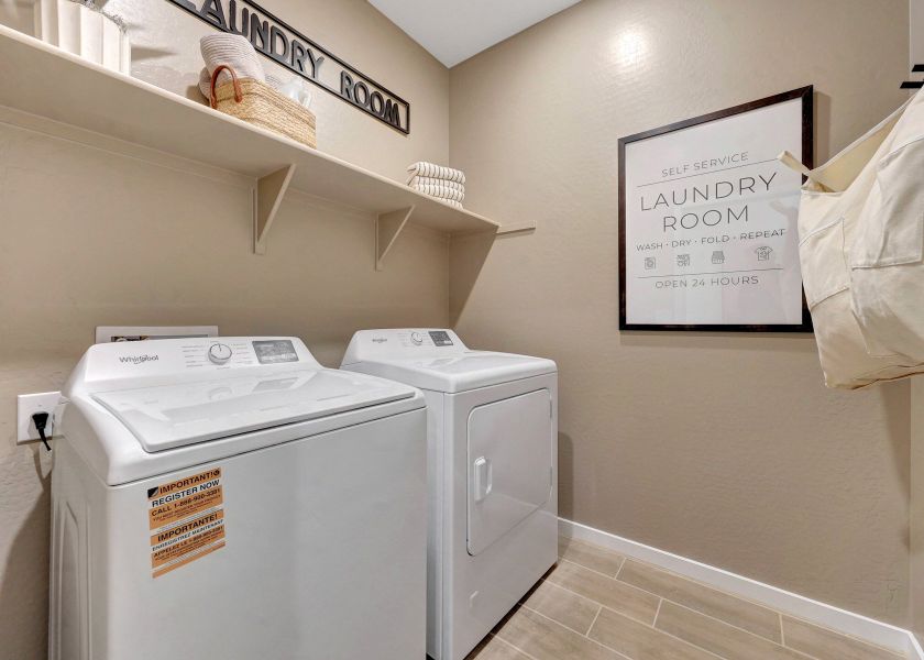 A laundry room with a sign.
