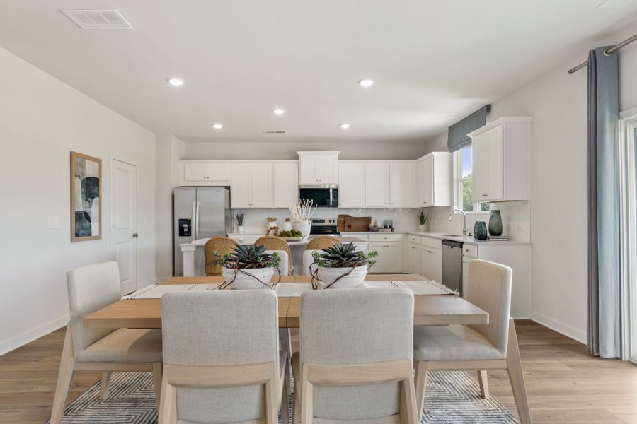 A kitchen with a dining table.