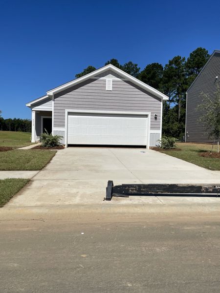A modern gray home with white garage in Watson Hill by Starlight Homes, Summerville, SC. A modern gray home with white garage in Watson Hill by Starlight Homes, Summerville, SC.
