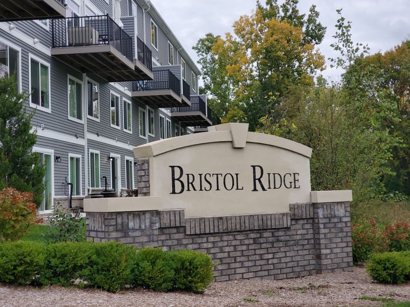Entrance to the Bristol Ridge Townhomes community in Ann Arbor, MI, featuring signage and landscaping (Image 2). Entrance to the Bristol Ridge Townhomes community in Ann Arbor, MI, featuring signage and landscaping (Image 2).