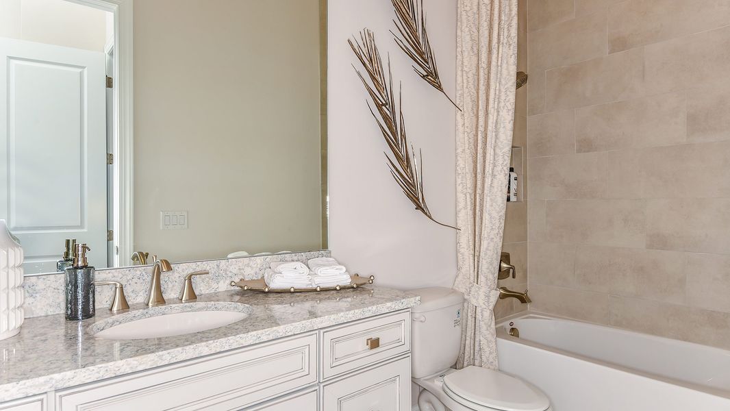 Furnished interior in a model home at Esplanade by the Islands in Naples (Image 54).