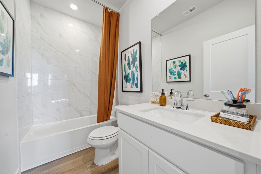 A bathroom with a tub sink and toilet.
