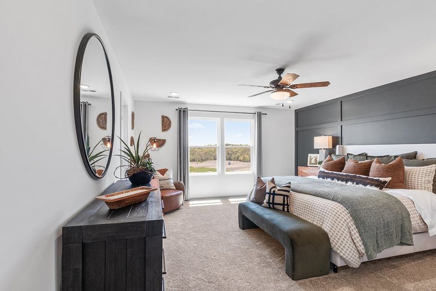 A bedroom with a large mirror. A bedroom with a large mirror.