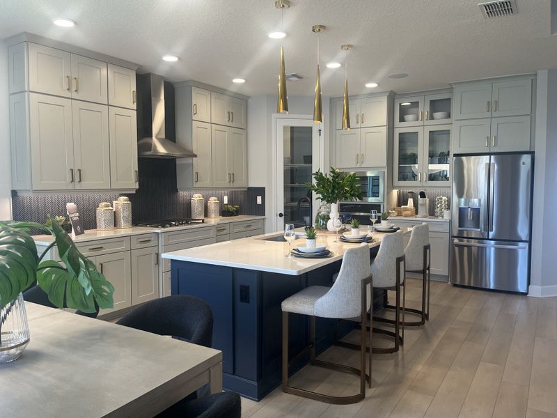 A modern kitchen featuring an island with pendant lighting, sleek cabinetry, and stainless steel appliances. A modern kitchen featuring an island with pendant lighting, sleek cabinetry, and stainless steel appliances.