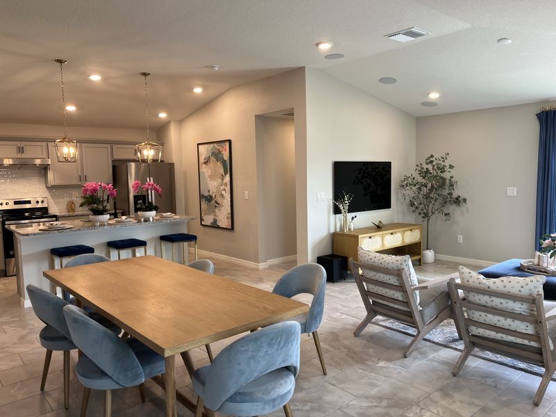 A modern open-concept living area with cozy seating, elegant dining, and a stylish kitchen with pendant lighting. A modern open-concept living area with cozy seating, elegant dining, and a stylish kitchen with pendant lighting.