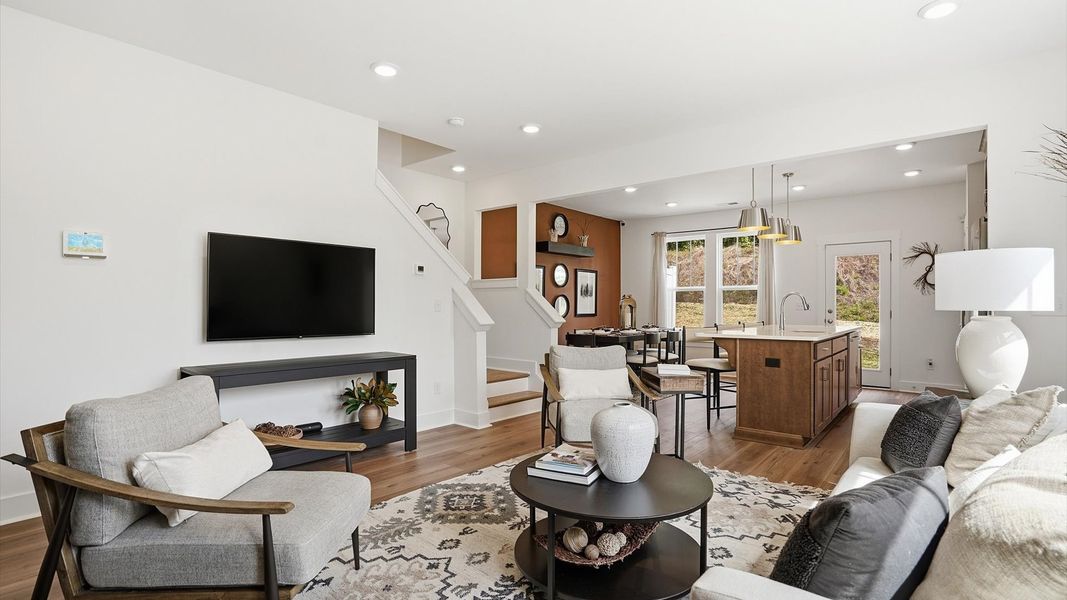 Eye-catching family room with elegant millwork and seamless access to dining and kitchen located near Downtown Greenville