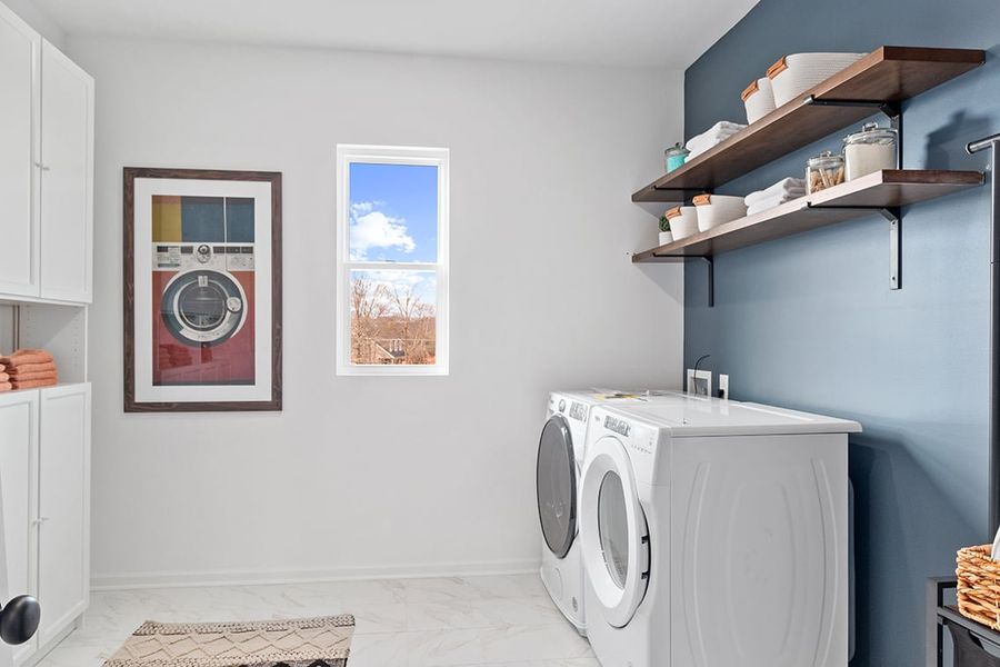 A laundry room with a washer and dryer. A laundry room with a washer and dryer.