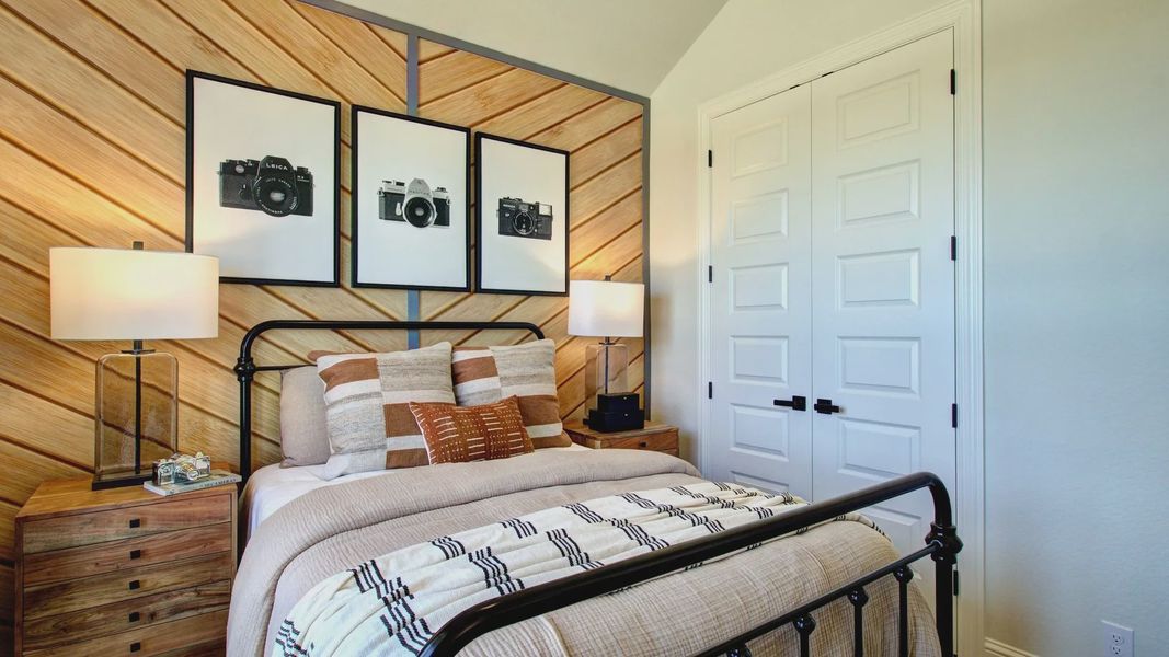 Meyer Ranch bedroom with unique wood chevron wall, elegant metal bed, and chic decor. Meyer Ranch bedroom with unique wood chevron wall, elegant metal bed, and chic decor.