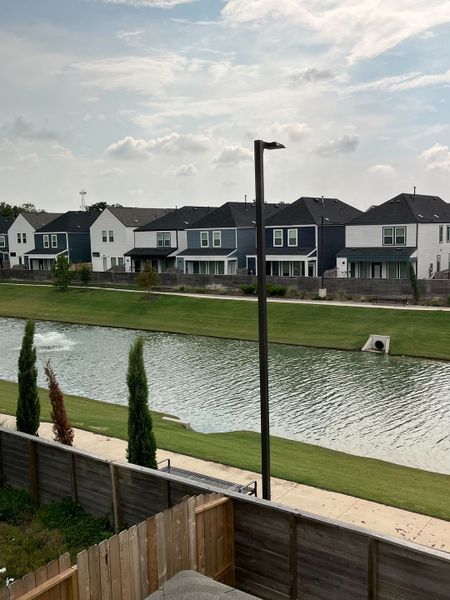 Charming homes with waterfront views and lush greenery in Cay Landing by First America Homes (Houston, TX).