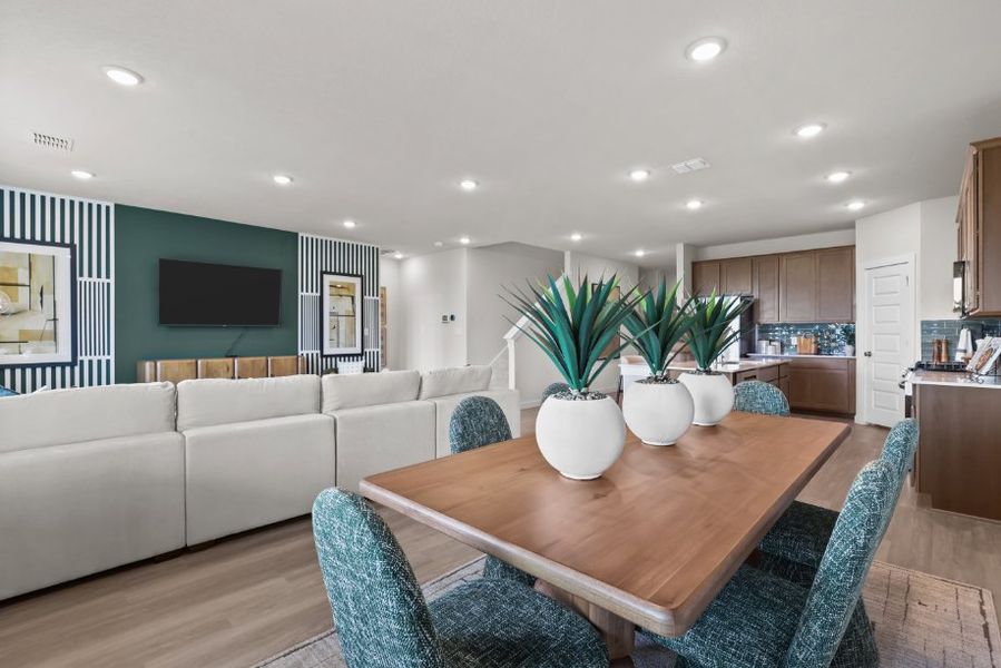 A living room with a table and chairs. A living room with a table and chairs.