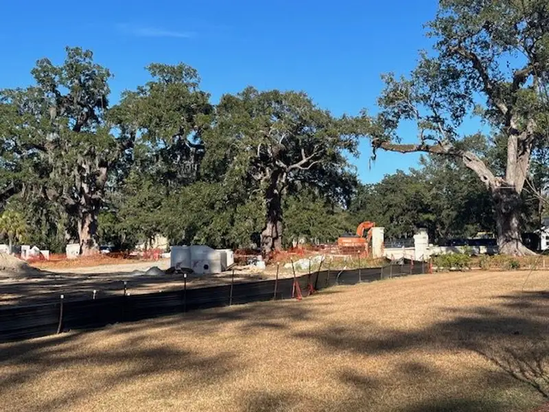 A picturesque construction site with mature trees, set in The Oaks by Beazer Homes (Goose Creek, SC).