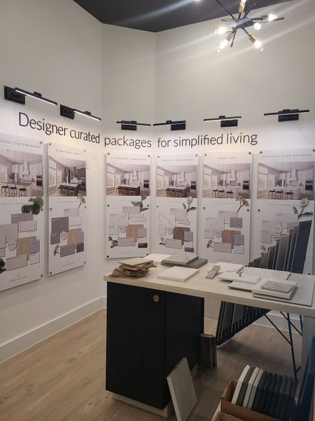 A design studio with curated material packages on display, modern lighting, and a sleek counter showcasing samples. A design studio with curated material packages on display, modern lighting, and a sleek counter showcasing samples.