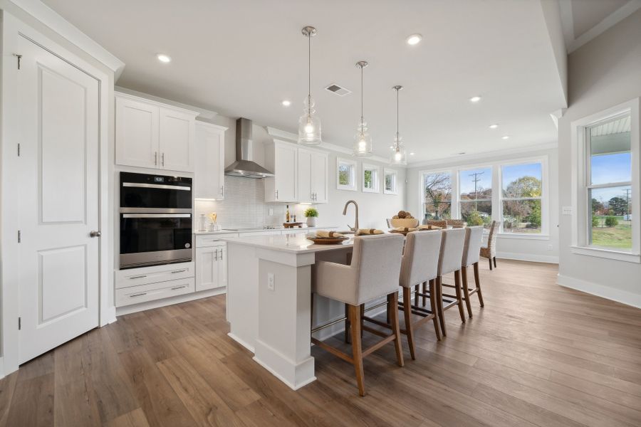 A kitchen with a dining table and chairs. A kitchen with a dining table and chairs.