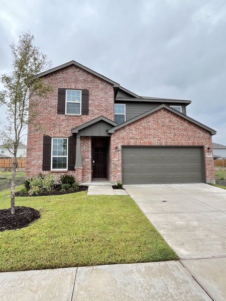 A charming red brick home with dark shutters and a tidy lawn in Ashford Crossing by Centex (Princeton, TX). A charming red brick home with dark shutters and a tidy lawn in Ashford Crossing by Centex (Princeton, TX).