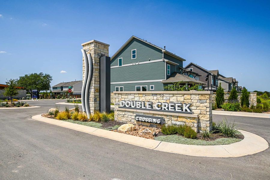 Entrance to the Double Creek Crossing – Craftsman Series community in Round Rock, TX, featuring signage and landscaping (Image 1).