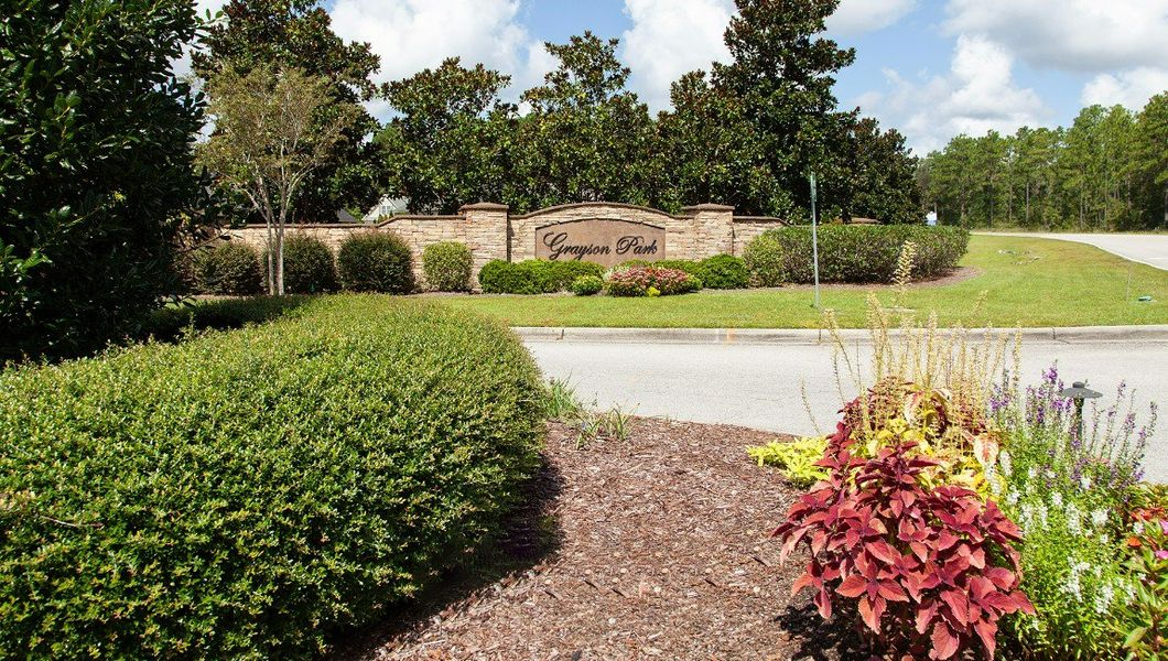 Entrance to the Grayson Park Townhomes community in Leland, NC, featuring signage and landscaping (Image 15).