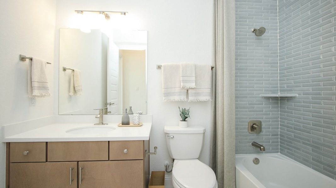 Impeccable subway tile and minimalist fixtures create a serene oasis in Sunterra.