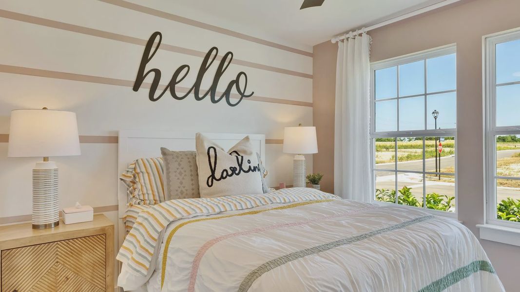 Luxurious bedroom features chic striped walls, high-end lighting, and vibrant bedding in Hunters Glen. Luxurious bedroom features chic striped walls, high-end lighting, and vibrant bedding in Hunters Glen.